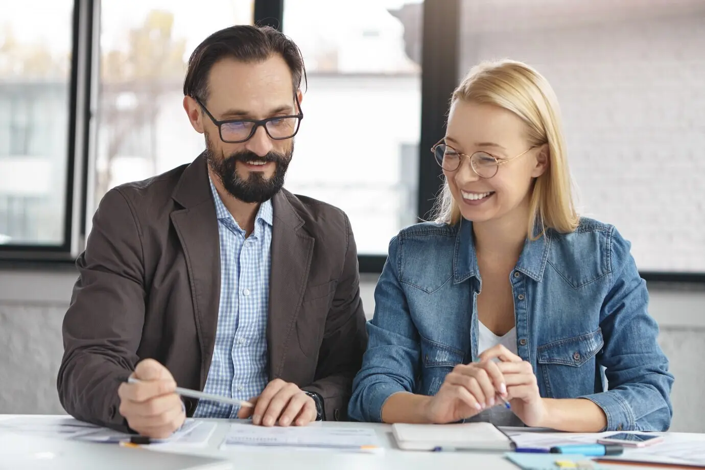 Blonde woman talking with a work colleague.